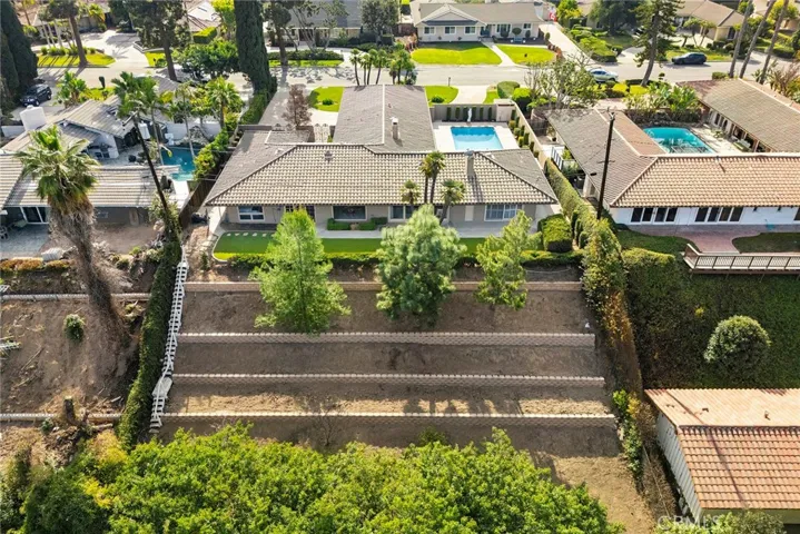 Backyard has a brand new retaining wall and has been terraced. Neighbors' influences are evident, as nearby properties boast amenities like a casita or a sparkling pool.