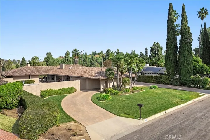 This beautiful home has an impressive driveway with elegant pavers. This spacious driveway provides for ample parking and fun bounce house parties! Impressive wrought iron gates and a private front courtyard welcome your family and friends.