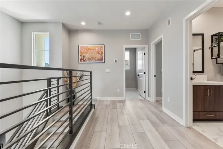 ELEGANT CONTEMPORARY METAL OPEN STAIR RAIL WITH DESIGNER LUXURY VINYL PLANK FLOORING.