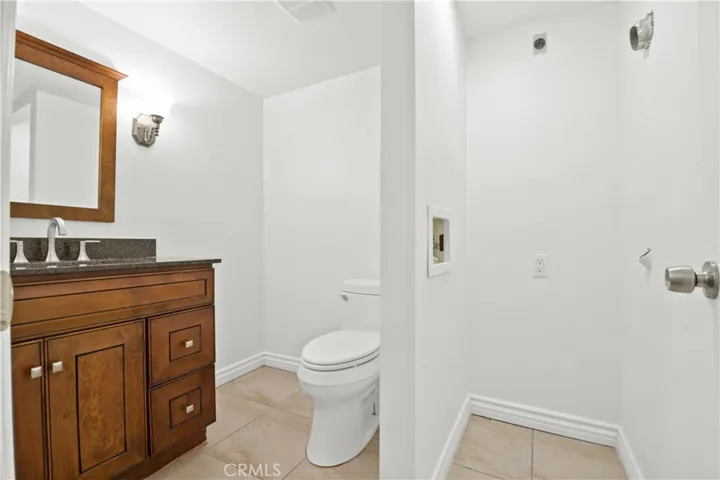 downstairs bathroom with laundry hook ups, Stackable