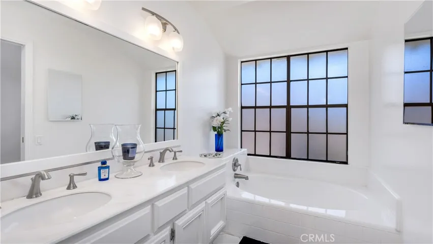 The Primary Bath has a separate tub and shower and dual sinks. An unusual big window too!