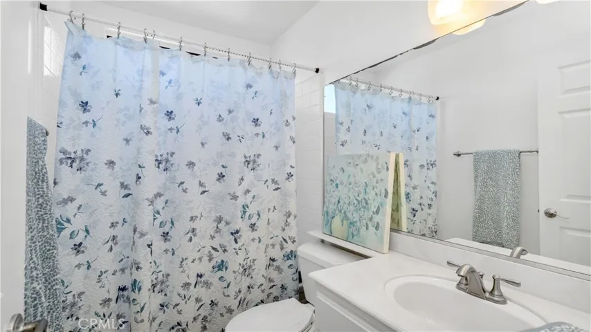 A lovely hall bath with shower over the tub