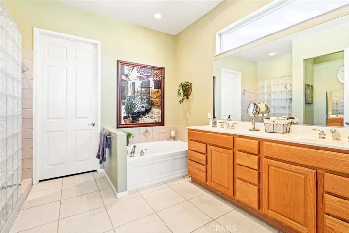 Double-Sinks, Separate Oval Tub and Remodeled Shower in Primary Bathroom. Door leads to Huge Walk-In Closet.