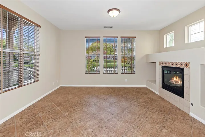 Light and bright Llving room with tile floors, fireplace