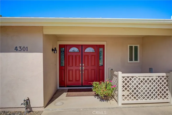 Inviting double beveled glass front doors and side-lights