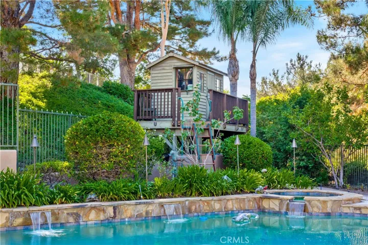 Tree House Overlooking Sparkling Pool and Backyard