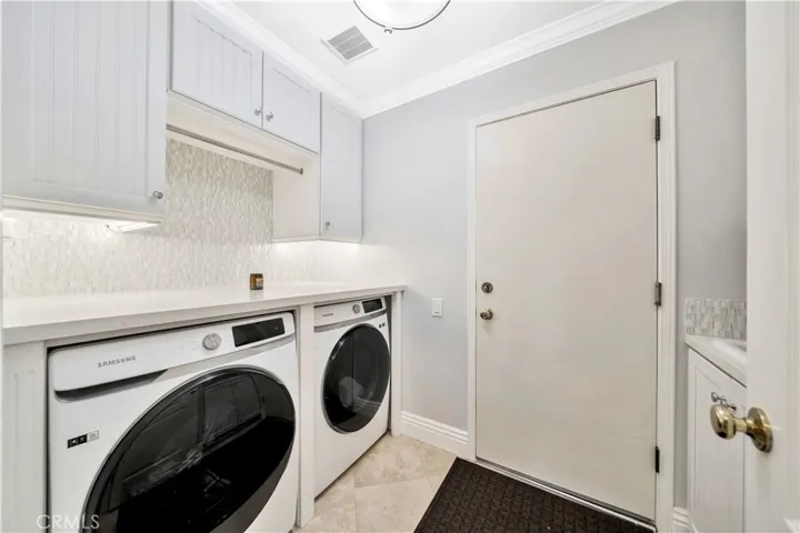 Laundry Area With Custom Undermount Accent Lighting And Pull Out Drying Rack.