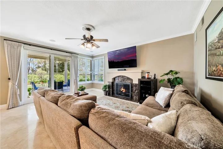 Den with Gas Fireplace and Sliding Glass Door Out to Backyard Seating Area
