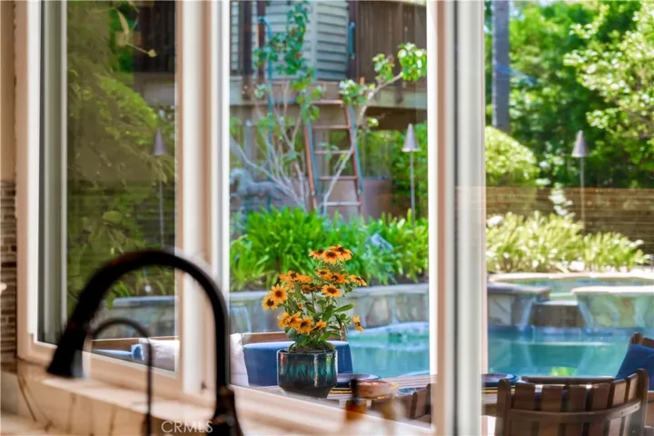Kitchen Views Pool, Spa, BBQ Island And Seating Areas.