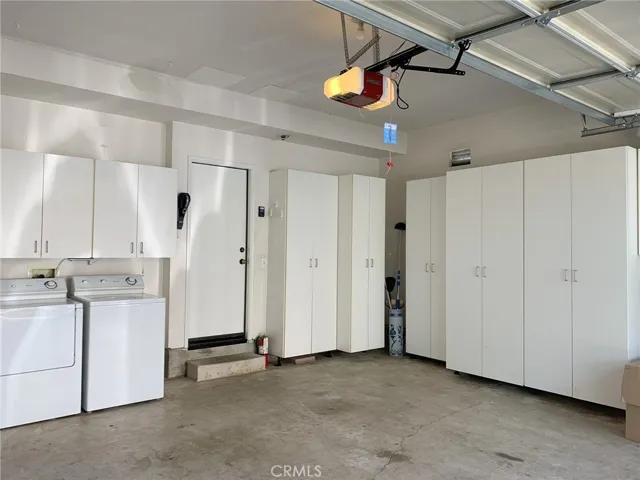 Two car garage plus plenty of cabinets for storage