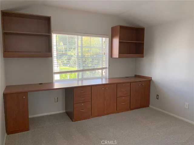 Second bedroom features a built-in desk with cabinets. Both bedrooms offer California Closet organizers