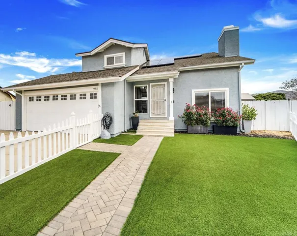 A freshly painted white picket fence & lush green turf adds a touch of charm and curb appeal.
