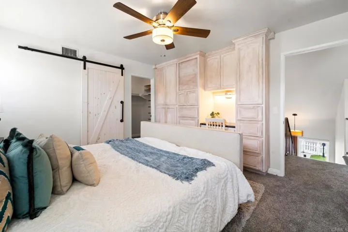 Primary with new carpet & custom built-ins, including amour & desk.