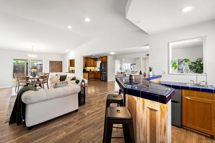 Combination of a wet bar w/ fridge & freezer in creates a stylish place for hosting gatherings.