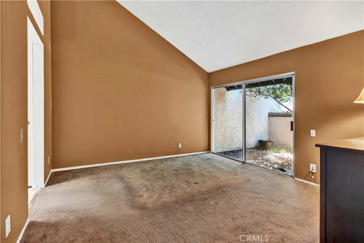 Primary Suite has Soaring Vaulted Ceiling, Slider to Private Patio, 2 Closets, and Ensuite Bathroom