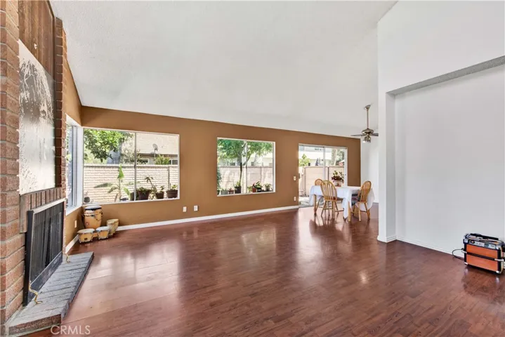 Living Room has Wood Laminate Flooring and Fireplace