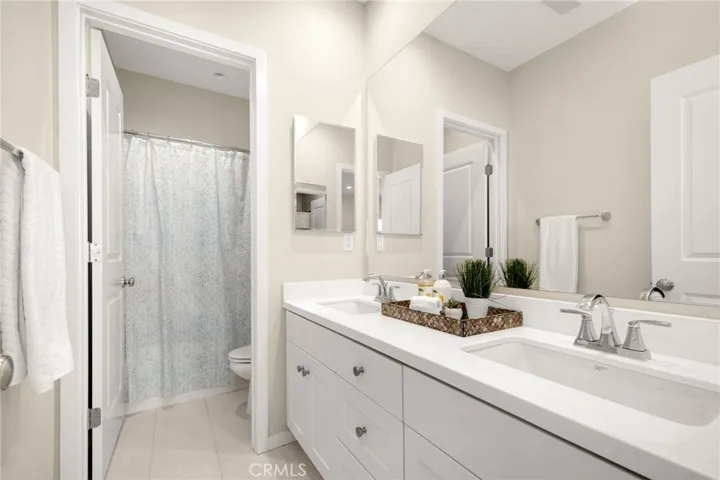 Full bath upstairs with double sinks.