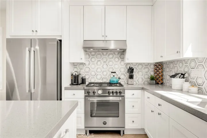 Upgraded tile backsplash and quartz counter tops in kitchen.