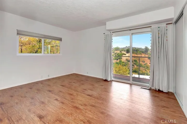 Main level guest bedroom with access to terrace and ocean views