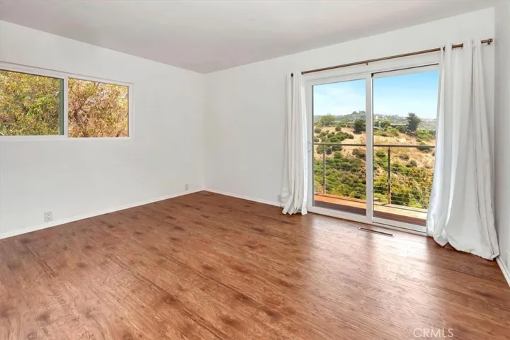 Downstairs guest bedroom with hillside and ocean views