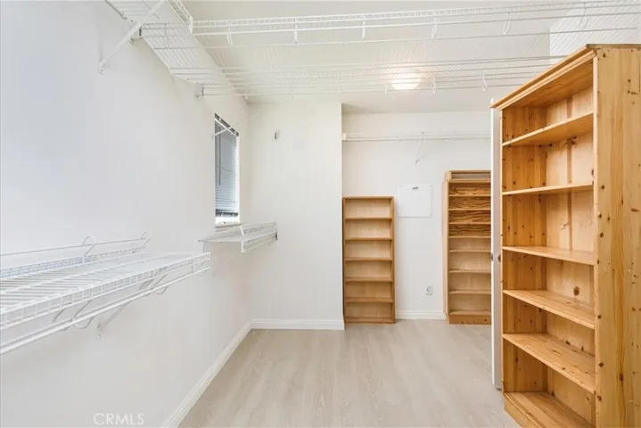 Looking through to other side of walk in His and Her closet