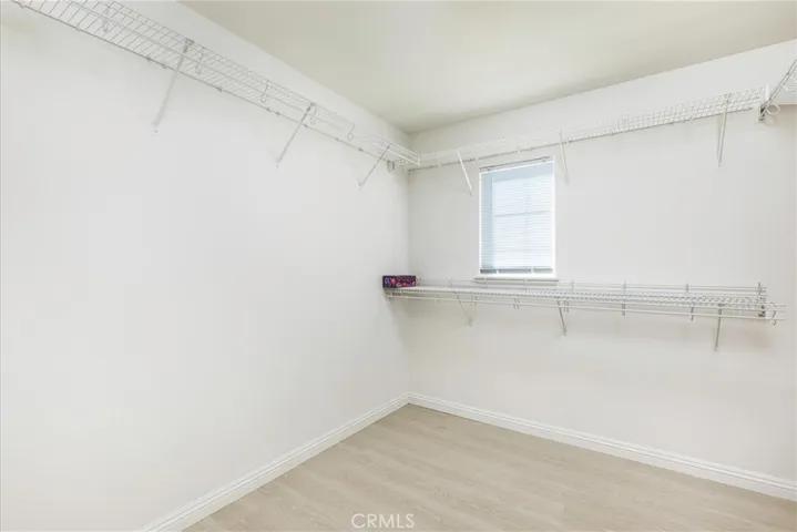 Walk in closet with two doors to seperate closets.
