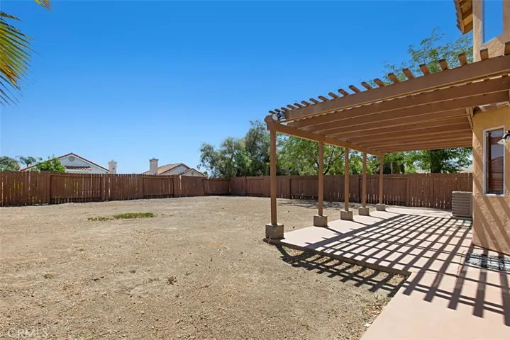Wide patio with cover provide a great head start on the backyard of your dreams