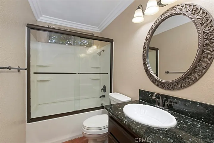 Upgraded hall bathroom is nestled near secondary bedrooms