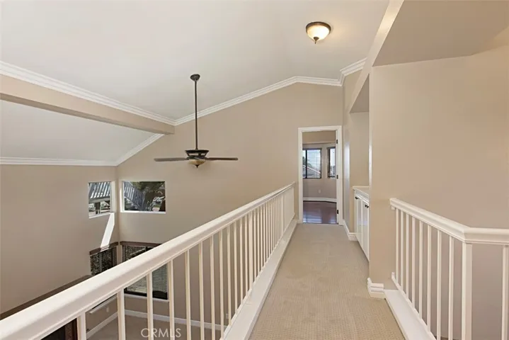 Lovely, open hallway to primary suite with linen cabinets & counter