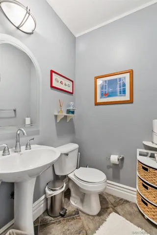 Half bathroom located off the kitchen downstairs