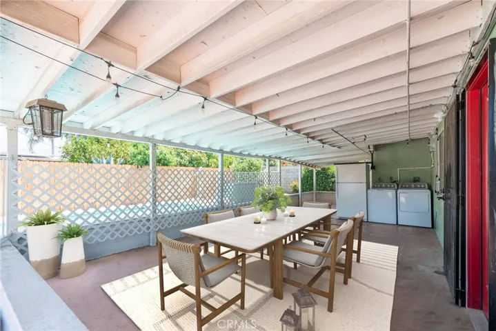 VIRTUALLY STAGED covered patio which is right off of the kitchen and has view of the pool and backyard. Washer and Dryer not included in sale.