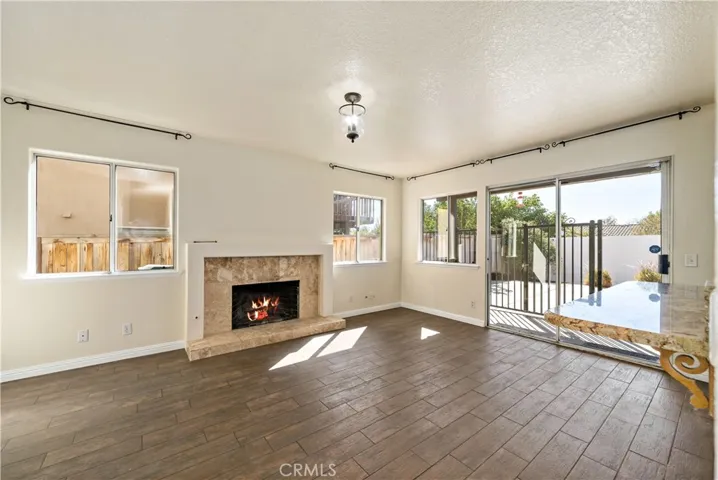 Family room w fireplace & glass sliding doors to rear patio and pool area.
