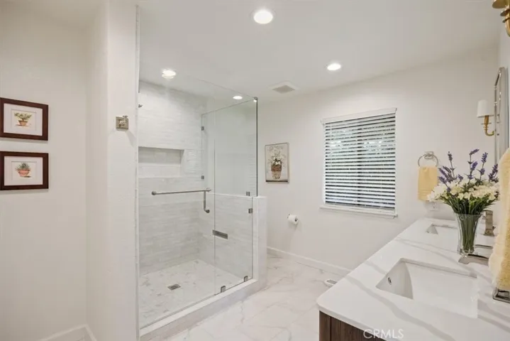 Tiled shower in primary bathroom