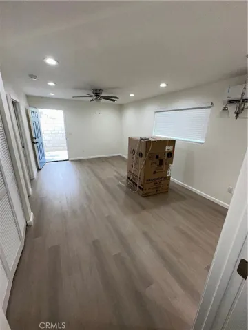 Living room with new washer and dryer sitting there