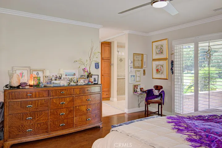 Another view of the primary bedroom suite. Entry to the bathroom can be seen at center background.