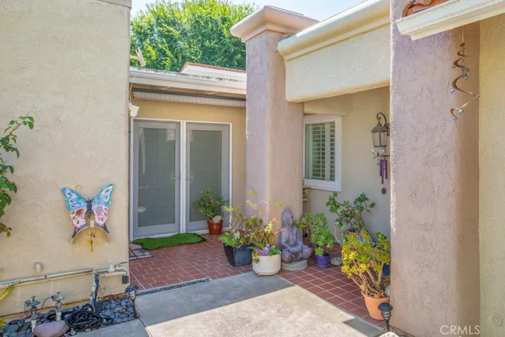 Just off the front courtyard is a separate entrance to the expanded guest bedroom.