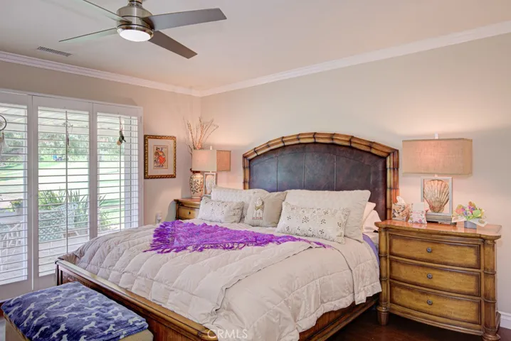 Large primary bedroom suite has direct access to the covered rear patio.