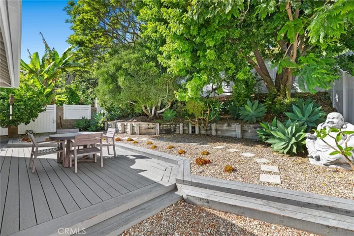  Lush landscaping creates appreciated privacy in a wraparound backyard that also displays fresh hardscaping.