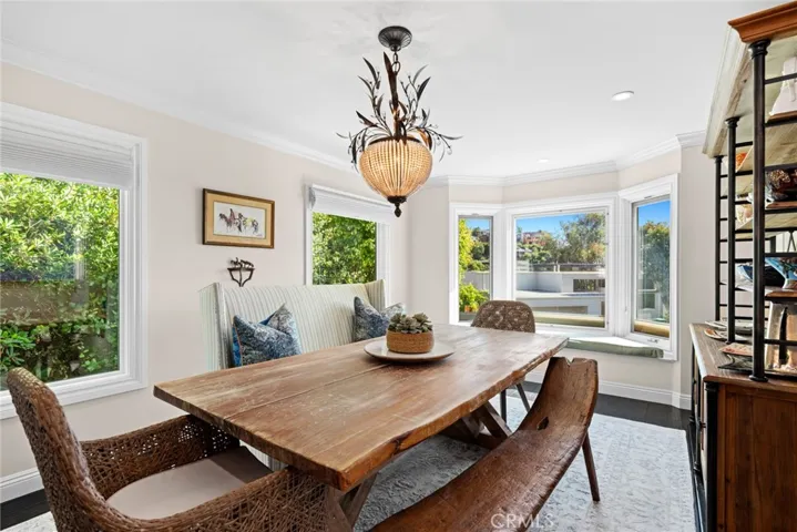  A charming bay window frames a peek at the ocean from the dining room.