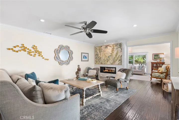 The family room shares a custom see-through linear fireplace with the living room.