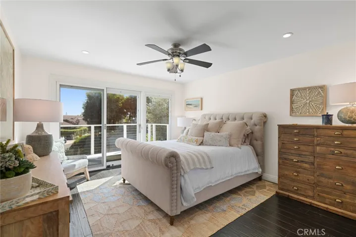  One bedroom offers direct access to a spacious front deck that is enriched with neighborhood views, providing a serene sanctuary for guests.