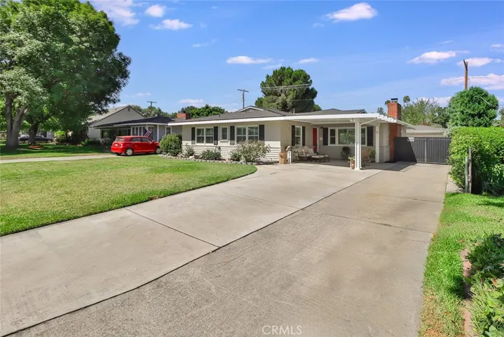 Beautiful landscaped front yard with large covered porch and plenty of parking