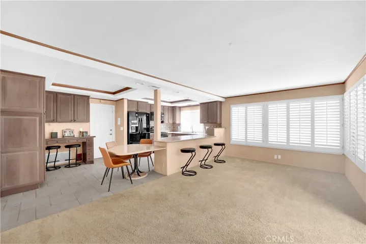 Large Family Room is Open to Kitchen with Wrap-Around Breakfast Bar and Built-In Desk Niche