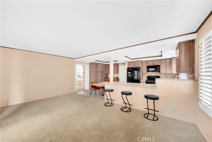 Family Room & Kitchen with Wrap-Around Breakfast Bar