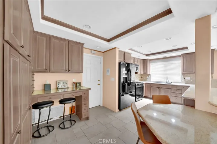 Pantry with Pull-Outs, Built-In Desk Niche, and Added Granite Countertop to Extend Breakfast Bar