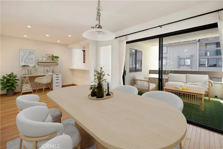 Dining room and den/office/flex space with connected covered patio and pass-through kitchen. Photo has been virtually staged.