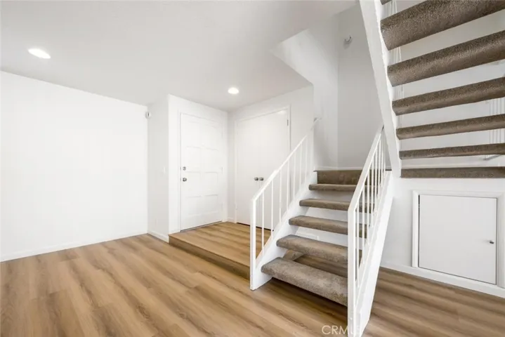 Entry has a large closet that extends storage under the stairs.