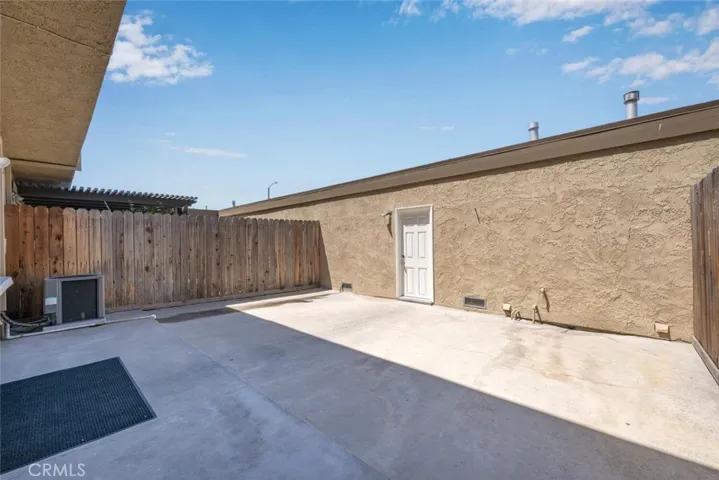 Large patio for outdoor living or safe play area for children.
