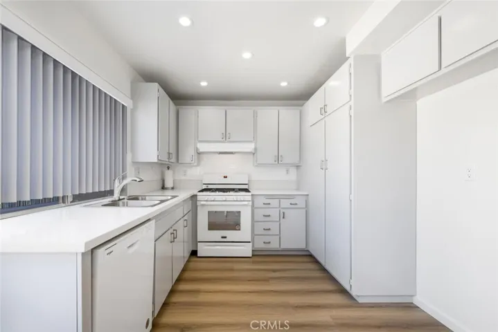 Nicely upgraded kitchen with quartz countertops and stainless-steel sink.