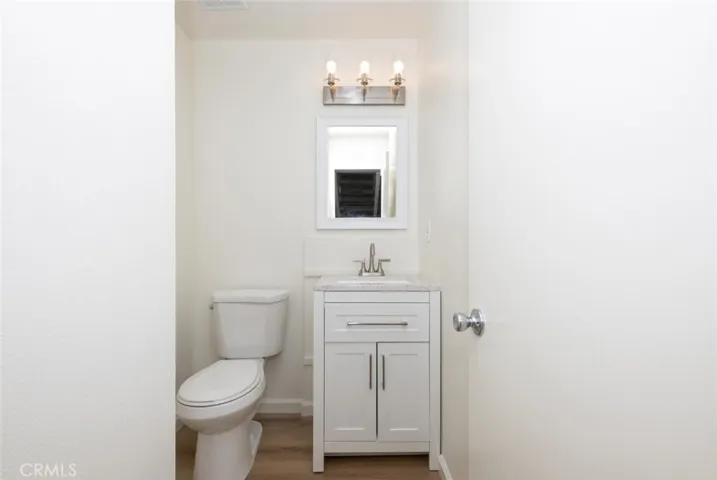 Powder Room features new vanity, toilet, and fixtures.